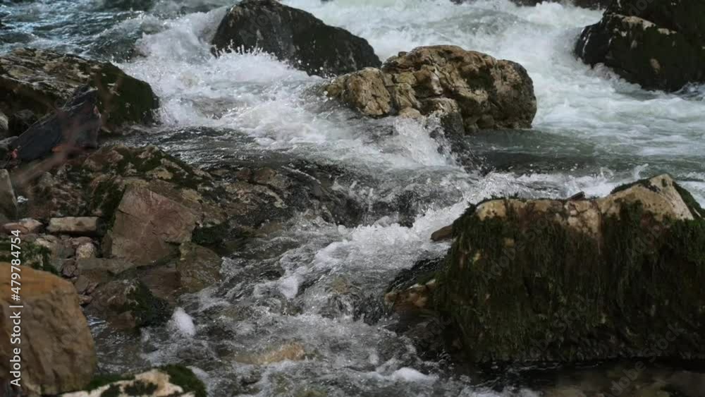Water flowing over rocks in Rakov Skocjan. A natural bridge in Slovenia. Shot in 60 and 120fps for slow-motion. The rocks are covered in moss, Water flowing over rocks in Rakov Skocjan. A natural bridge in Slovenia. Shot in 60 and 120fps for slow-motion. The rocks are covered in moss,
