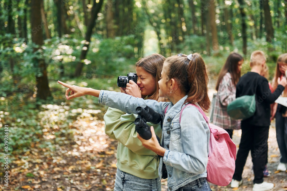 Fototapeta premium Looking for a path. Kids in green forest at summer daytime together