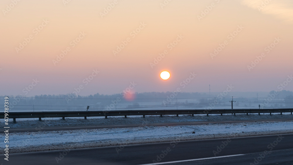 Winter landscape in snow nature with sun, field and trees. Magical winter sunset in a snow field. Winter landscape in snow nature with sun, field and trees. Magical winter sunset in a snow field.
