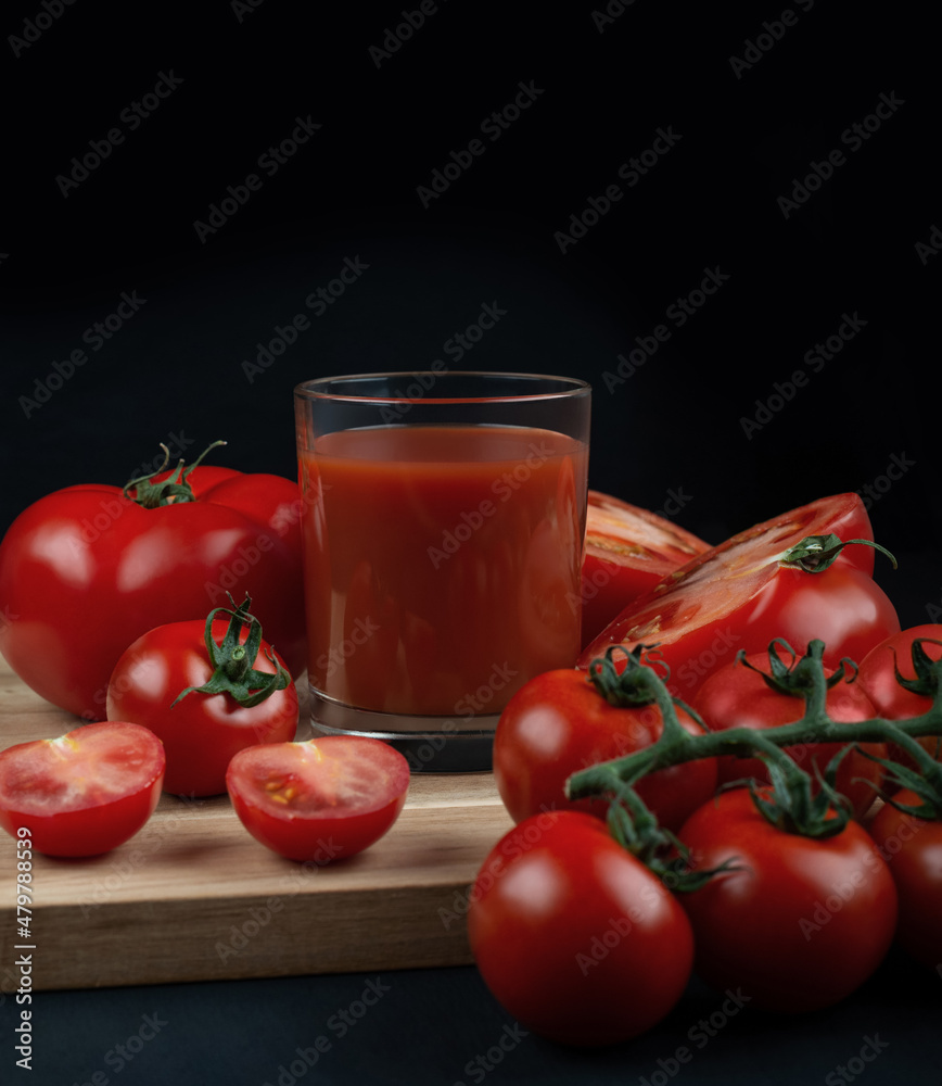 preparing tomato juice on a black wooden table preparing tomato juice on a black wooden table
