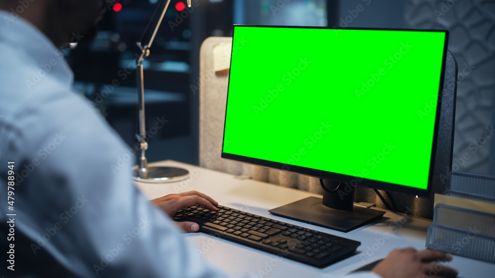 Close Up of a Businessman Working on Desktop Computer with Chroma Key Green Screen Mock Up Display. Male Executive Director Managing Digital Projects, Typing Data, Using Keyboard and Mouse. Close Up of a Businessman Working on Desktop Computer with Chroma Key Green Screen Mock Up Display. Male Executive Director Managing Digital Projects, Typing Data, Using Keyboard and Mouse.