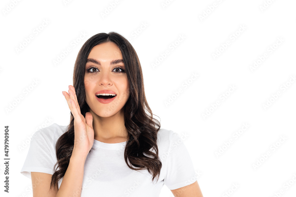 thrilled woman with open mouth holding hand near face while looking at camera isolated on white. thrilled woman with open mouth holding hand near face while looking at camera isolated on white.