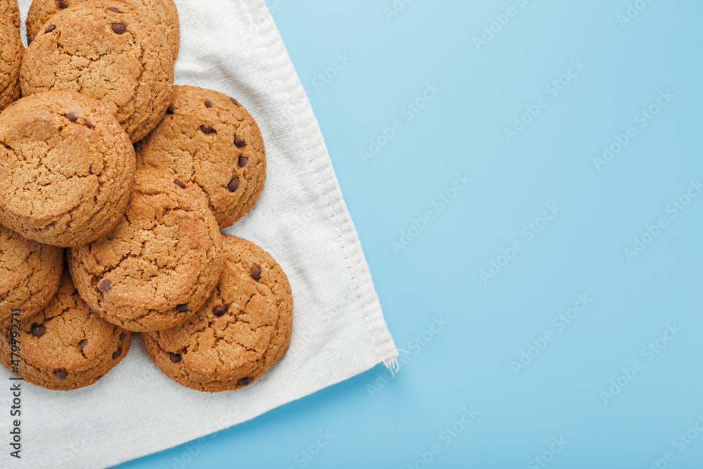 Oatmeal cookies on a blue background and a white napkin top view Oatmeal cookies on a blue background and a white napkin top view