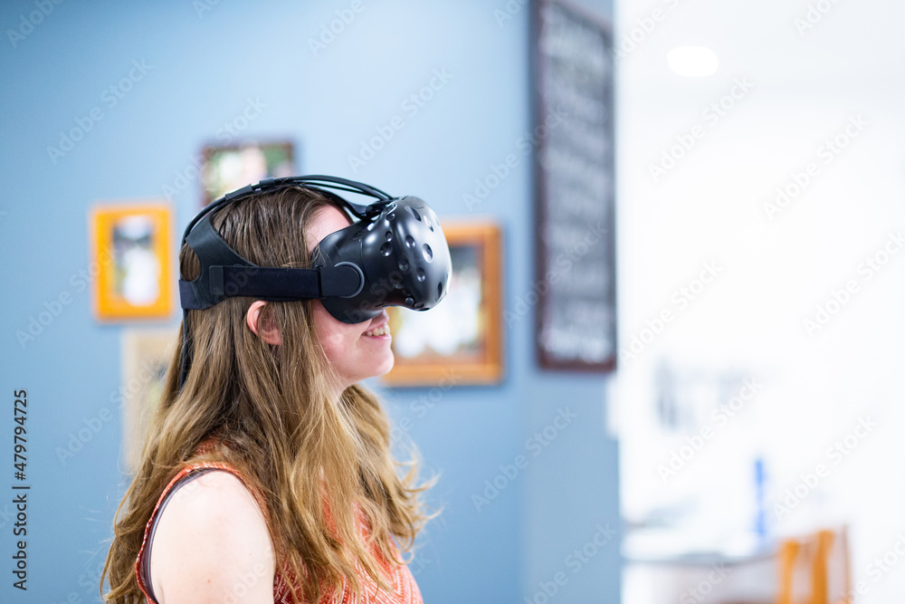 Young adult looking through vr headset at virtual reality Young adult looking through vr headset at virtual reality