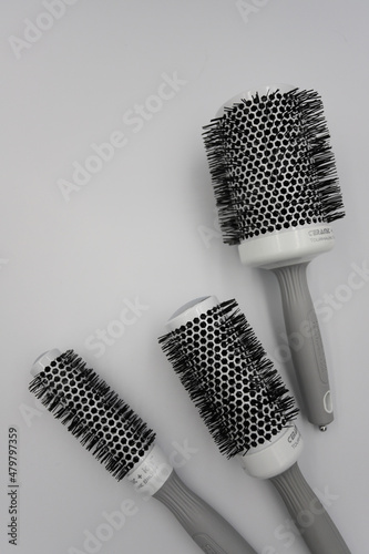 three round professional brushes of different sizes close-up on a light background photo