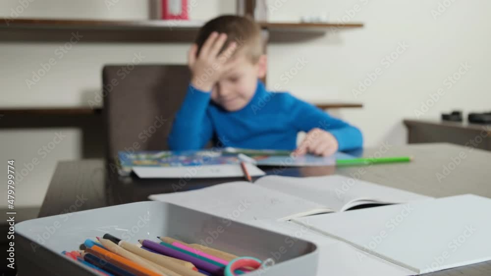 boy makes a mistake during homework. He gets upset and hits himself on the head. Distance learning online education. boy makes a mistake during homework. He gets upset and hits himself on the head. Distance learning online education.