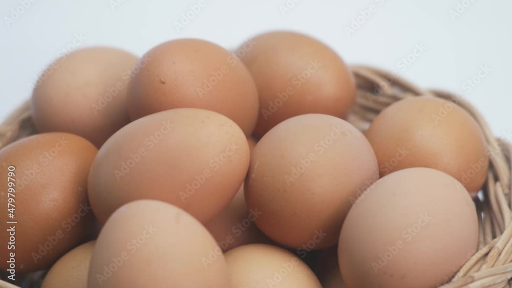 Closeup of Chicken egg rotates on white background. Rotating basket With Brown Eggs On Turntable.side view.Slowly Rotating video.Concept Fresh organic food.4K 2160p 30fps UltraHD footage Closeup of Chicken egg rotates on white background. Rotating basket With Brown Eggs On Turntable.side view.Slowly Rotating video.Concept Fresh organic food.4K 2160p 30fps UltraHD footage