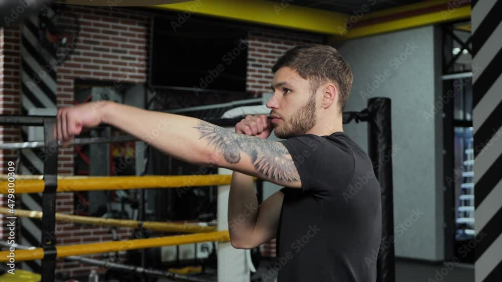 Brutal tattooed boxer who trains in the ring and hits a punching bag. Brutal tattooed boxer who trains in the ring and hits a punching bag.