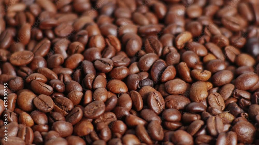 Coffee beans rotate slowly. Close up of dark Coffee Grains or Roasted arabica coffee bean.Top view.Rotating video.4K 2160p 30fps UltraHD footage Coffee beans rotate slowly. Close up of dark Coffee Grains or Roasted arabica coffee bean.Top view.Rotating video.4K 2160p 30fps UltraHD footage