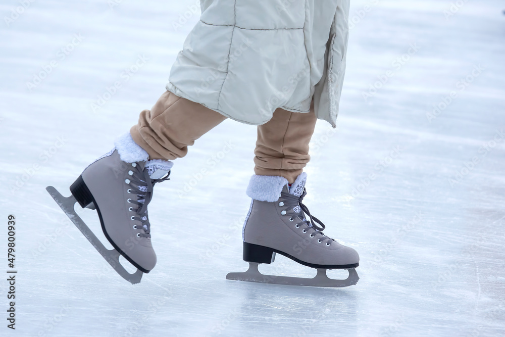 Ice skating on an ice rink. legs with skates. Winter active sport and leisure hobby. Ice skating on an ice rink. legs with skates. Winter active sport and leisure hobby.