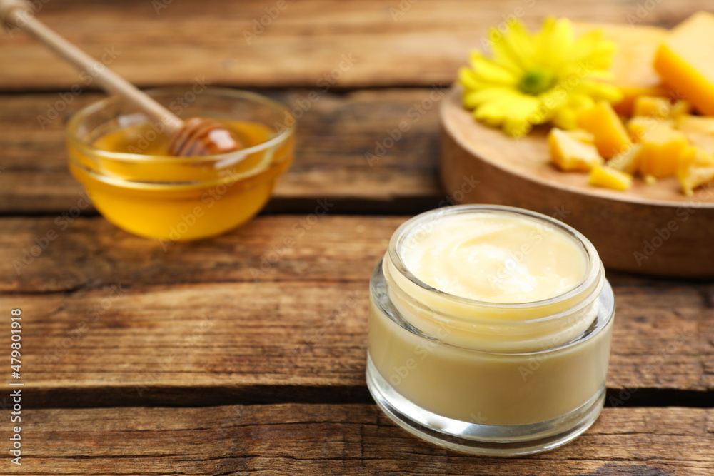 Cream with natural beeswax component on wooden table, closeup. Space for text Cream with natural beeswax component on wooden table, closeup. Space for text