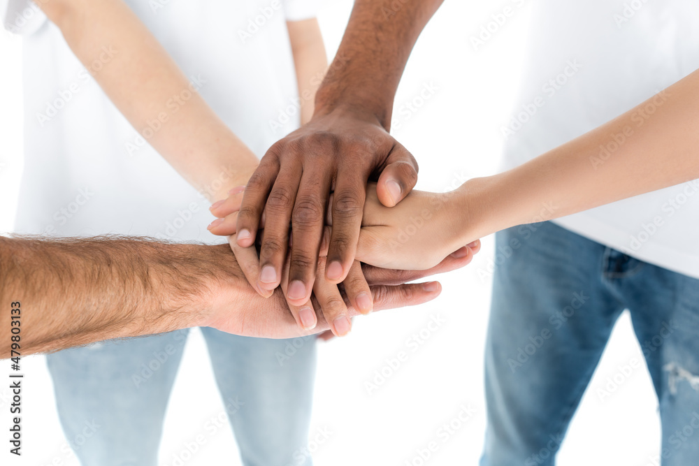cropped view of interracial people joining hands isolated on white. cropped view of interracial people joining hands isolated on white.