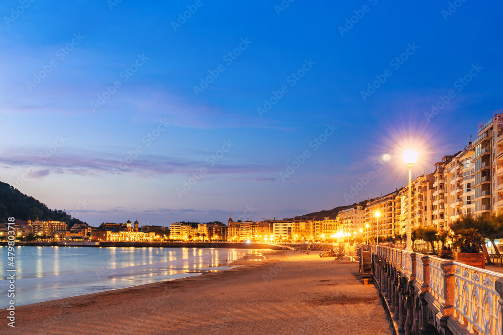 view at the blue hour of Concha beach and the promenade in Sao Sebastian, Spain.