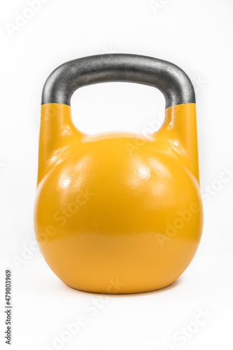 Classic heavy cast iron kettlebell, painted yellow against a white studio background.