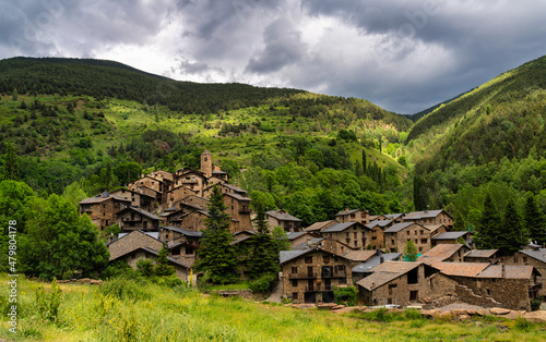 view of the rural village Os de Civís in the Catalan Pyrenees with the stone houses.