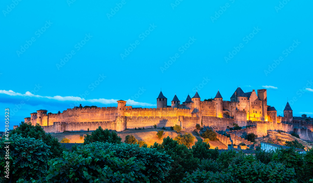 view of the castle at night in the medieval walled city of Carcassonne (La Cité) in France