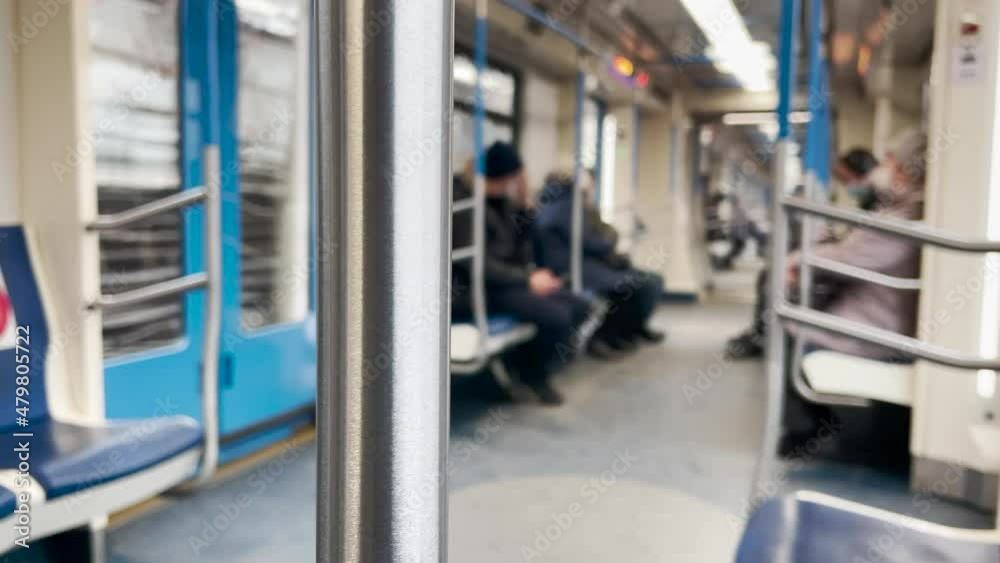 people in the subway car. blurred background transport coronavirus pandemic concept. people in masks in the subway car go to work. transport lifestyle metro concept