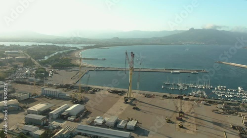 Drone footage of arbatax ferry port in Sardinia island, Italy. Aerial view of the harbor with crane and boat and coastline seascape photo