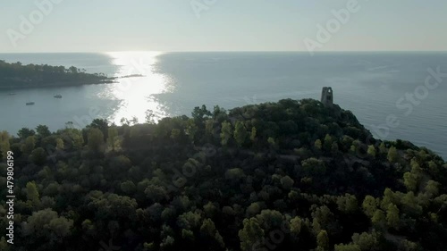 Aerial view of San gemiliano tower on the top of rock bound formation cliff in east coastline of Sardinia, Italy photo