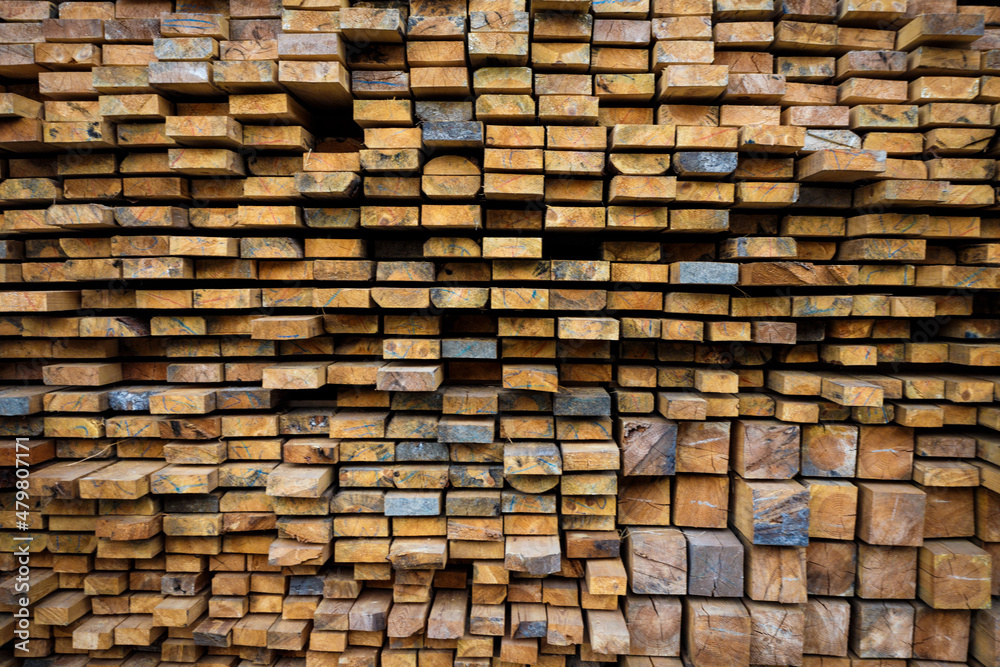 Wooden beams lie in a row. Woodworking and logging industry. Wooden beams lie in a row. Woodworking and logging industry.
