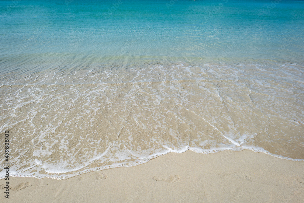 Beach with clear water with white and golden sand, blue sky, in tropical vacation area. Kata beach in Phuket, Thailand, a photo with copyspace. Beach with clear water with white and golden sand, blue sky, in tropical vacation area. Kata beach in Phuket, Thailand, a photo with copyspace.
