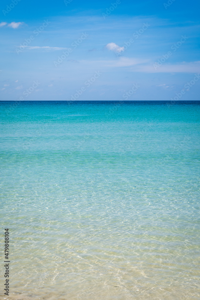 Beach with clear water with white and golden sand, blue sky, in tropical vacation area. Kata beach in Phuket, Thailand, a photo with copyspace. Beach with clear water with white and golden sand, blue sky, in tropical vacation area. Kata beach in Phuket, Thailand, a photo with copyspace.