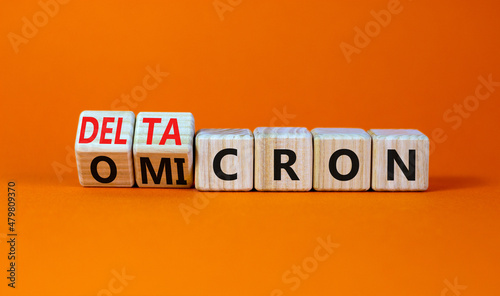 Covid-19 omicron or deltacron symbol. Turned cubes and changed the concept word omicron to deltacron. Beautiful orange background. Medical, covid-19 corona omicron or deltacron concept. Copy space.