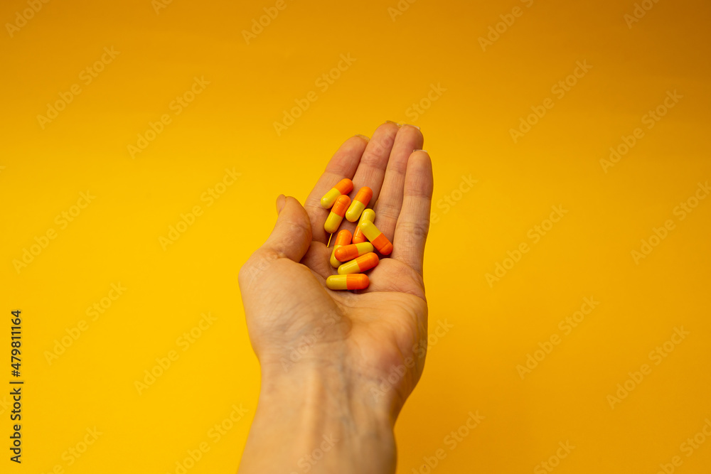 A girl holding a pill in her hand