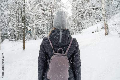 Woman in winter jacket walk...