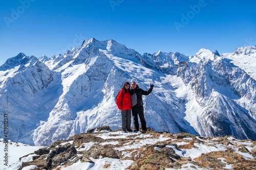 Couple in love on the background of snowy mountains