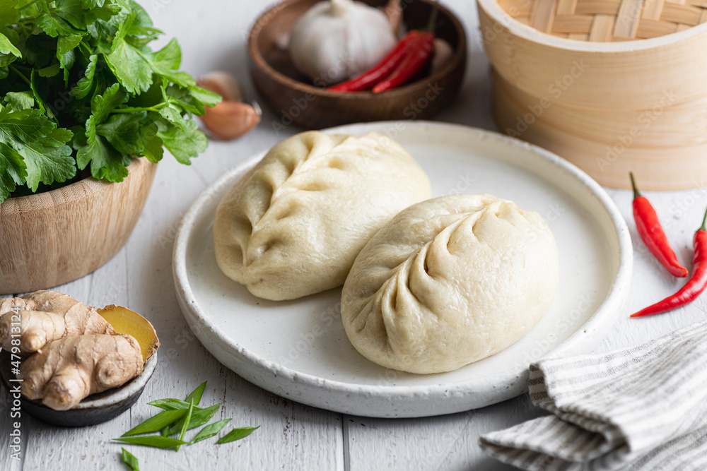 Traditional Korean steamed pie, pyanse or pigodi, on white wooden background, selective focus Traditional Korean steamed pie, pyanse or pigodi, on white wooden background, selective focus