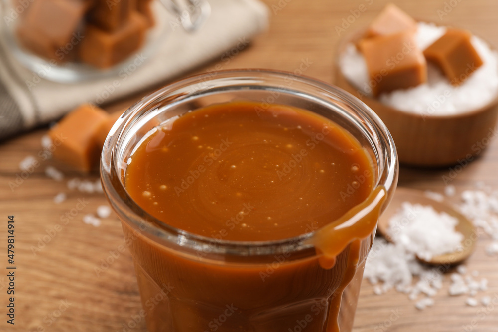 Tasty salted caramel in glass on table, closeup Tasty salted caramel in glass on table, closeup