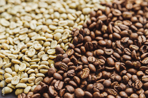 Raw green and roasted coffee beans texture background © vladdeep