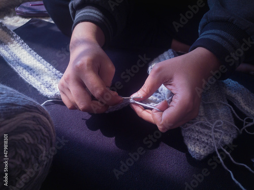 rural woman crochette knitting with crochet hook by hand. photo