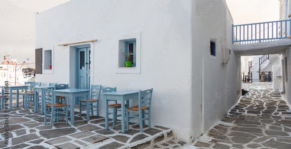 Outdoor cafe empty tables at Naousa old harbor. Greece, Paros island, Cyclades. Summer vacation