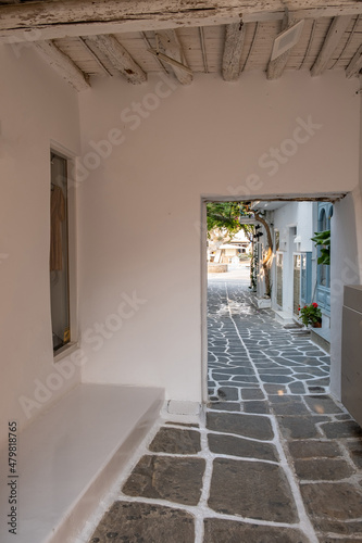 Paros island, Greece. Naousa old town. Whitewashed building, empty narrow cobblestone alley