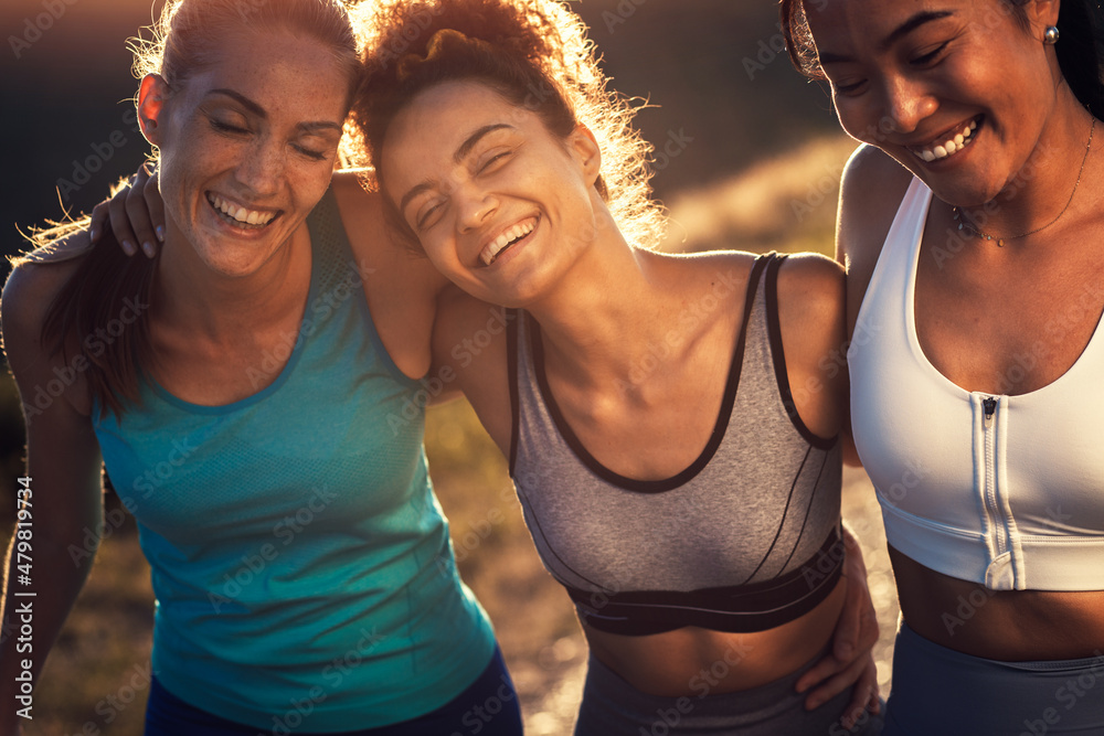 Fototapeta premium Portrait of three sporty young woman after running outdoors.