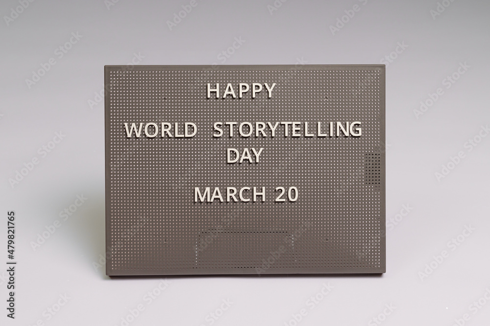 Happy World Storytelling Day 20 March lettering on gray chalkboard, white background Happy World Storytelling Day 20 March lettering on gray chalkboard, white background