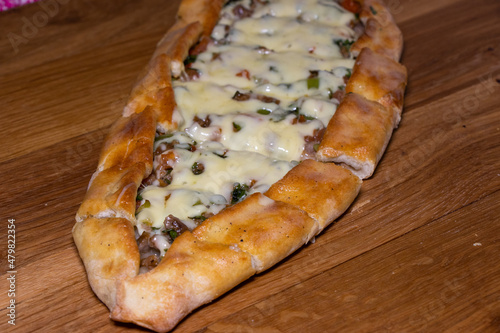 Turkish pizza - pide. Traditional pita with beef and cheddar cheese. Traditional flavors