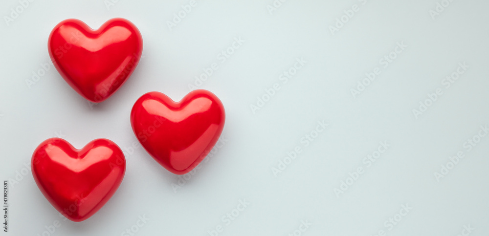Valentine's day concept with red hearts on light blue background, top view, copy space. . Valentine's day concept with red hearts on light blue background, top view, copy space. .