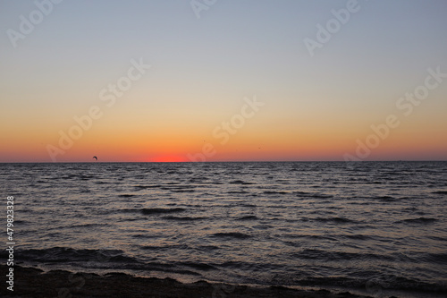 golden sunset or sunrise at the deep dark ocean. aerial view of sundown and up to the sea. yellow and orange colorful sky. romantic beautiful sky in the spring season.