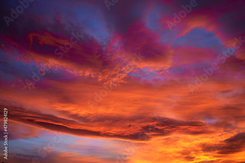Dramatic sunset sky with clouds of beautiful orange and magenta colors
