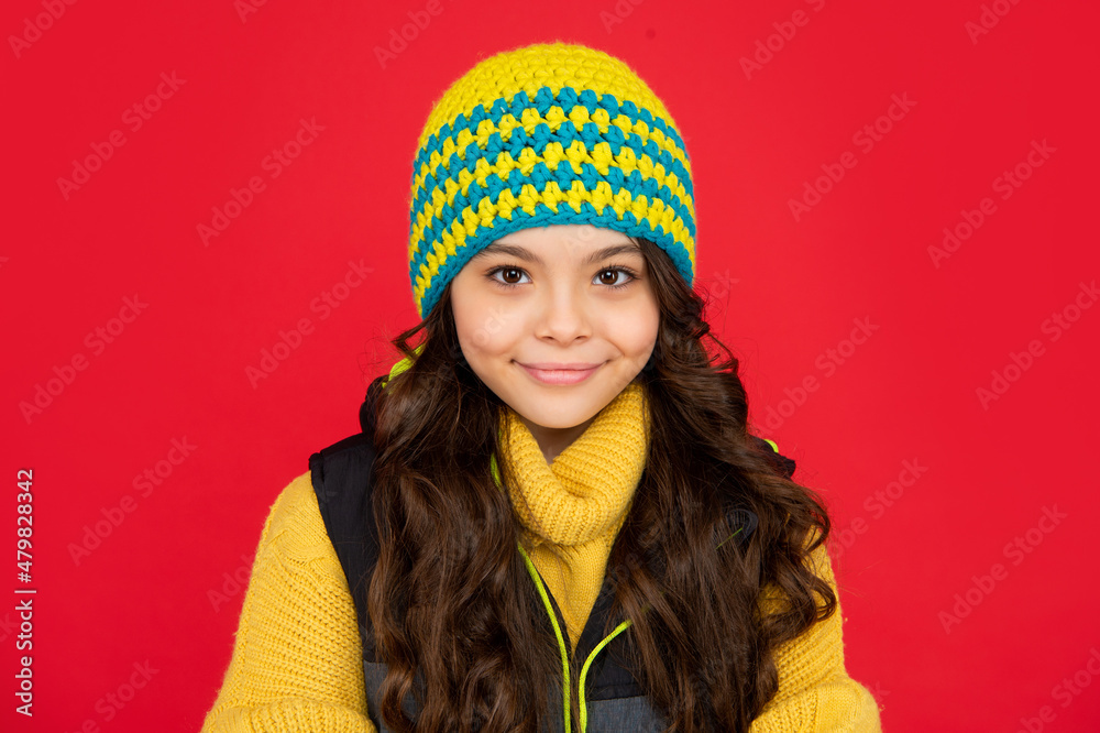 express positive emotion. winter fashion. smiling kid with curly hair in hat. teen girl express positive emotion. winter fashion. smiling kid with curly hair in hat. teen girl