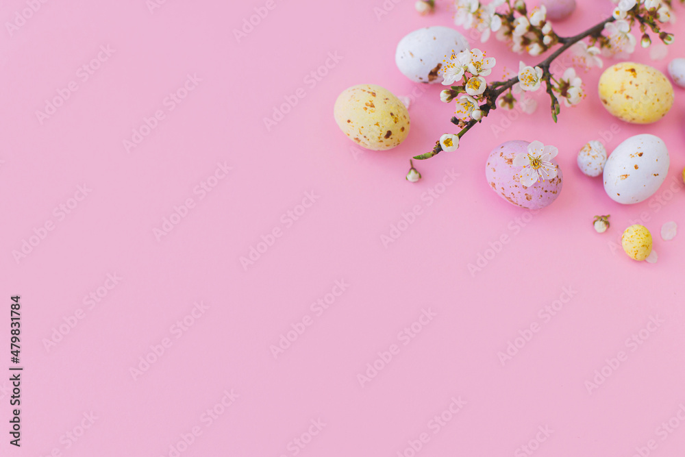 Fototapeta premium Easter banner. Colorful Easter chocolate eggs and cherry blossoms border on pink background. Happy Easter! Stylish tender spring template. Greeting card