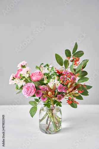 Fototapeta Naklejka Na Ścianę i Meble -  Finished flower arrangement in a vase for home. Flowers bunch, set for interior. Fresh cut flowers for decoration home. European floral shop. Delivery fresh cut flower.