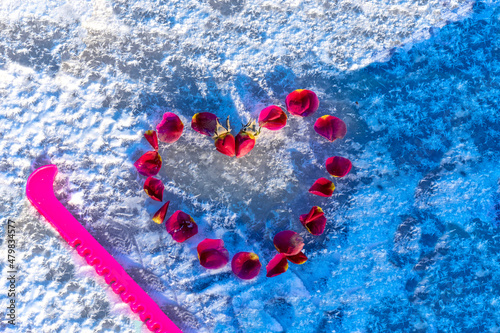 Rose petals are laid out on ice in shape of heart. Topic - Valentine s Day  Greeting Card