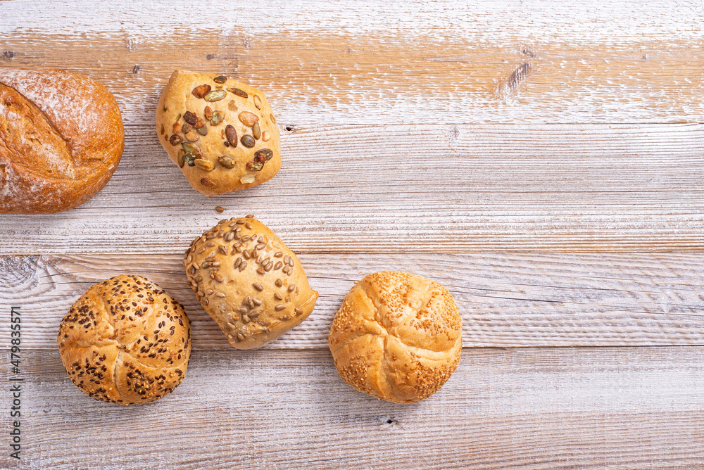 Buns with grains on a wooden table. Buns with grains on a wooden table.