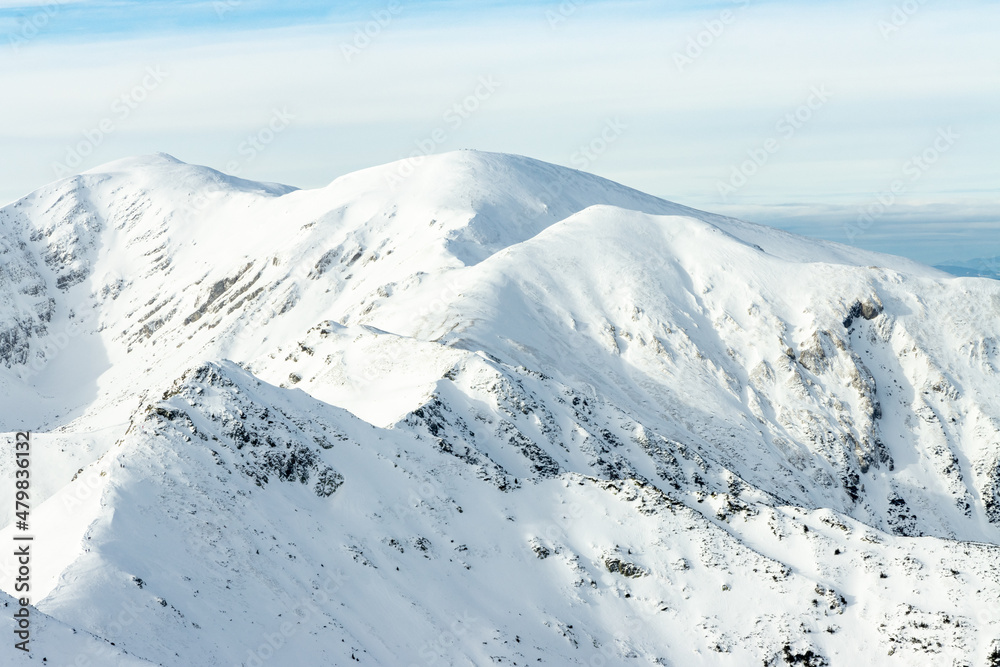 Tatra mountians at winter time. View of the white snow-capped peaks, frosty winter mountains. Kasprowy Wierch, High Tatra, Poland, Europe. Tatra mountians at winter time. View of the white snow-capped peaks, frosty winter mountains. Kasprowy Wierch, High Tatra, Poland, Europe.