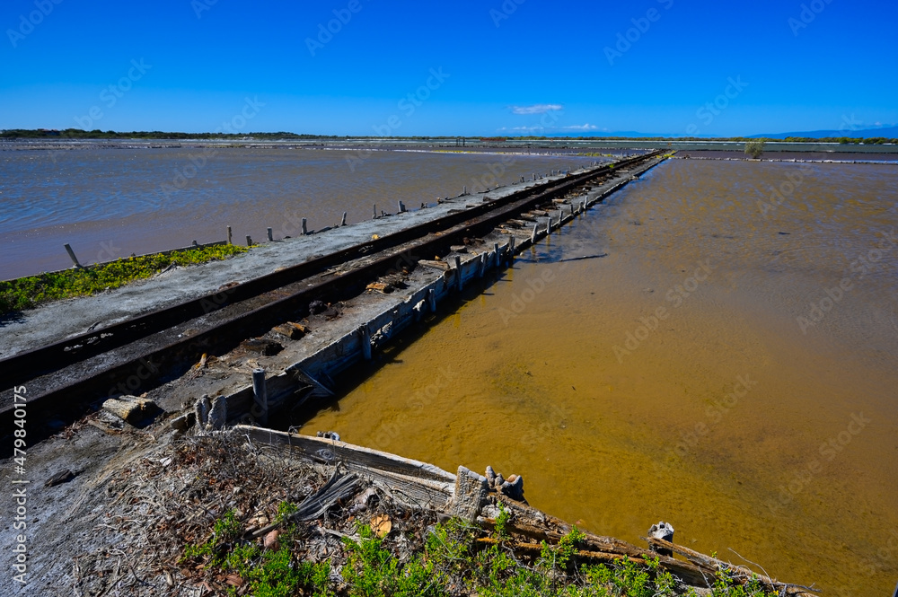 Narrow gauge railway on lakes for salt mining in the south of the Dominican Republic. The photo. Wide angle, Copy space, High quality photo