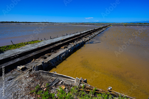 Narrow gauge railway on lakes for salt mining in the south of the Dominican Republic. The photo. Wide angle, Copy space, High quality photo photo